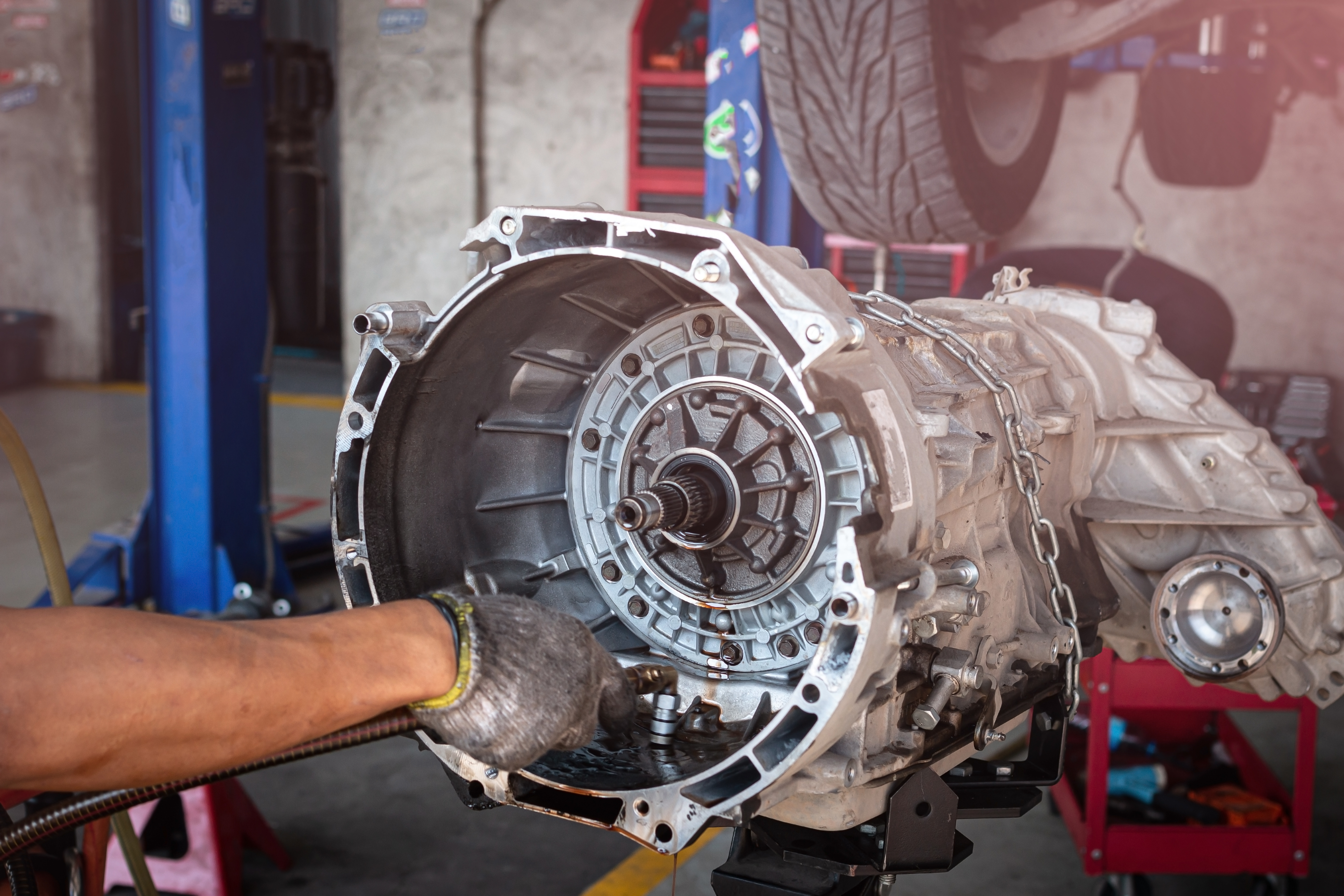 Mechanic removing transmission for rebuild